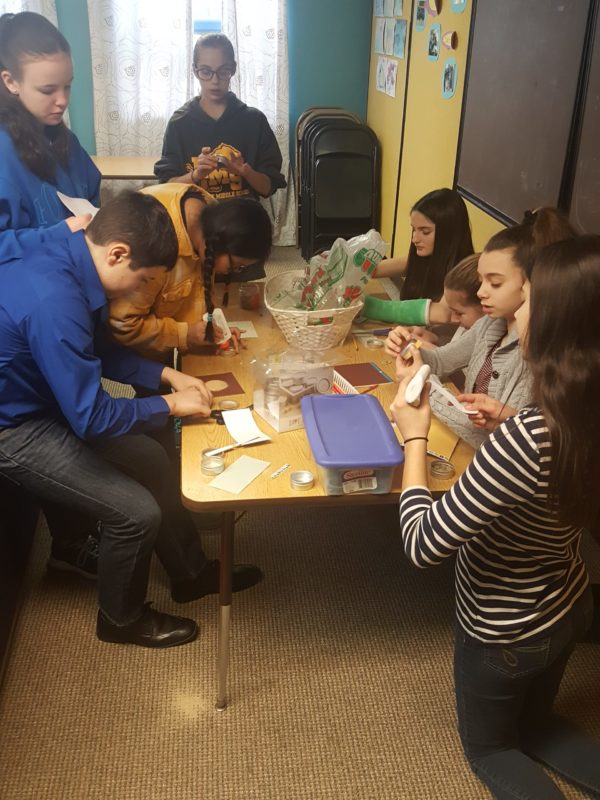Young people working on a project around a table