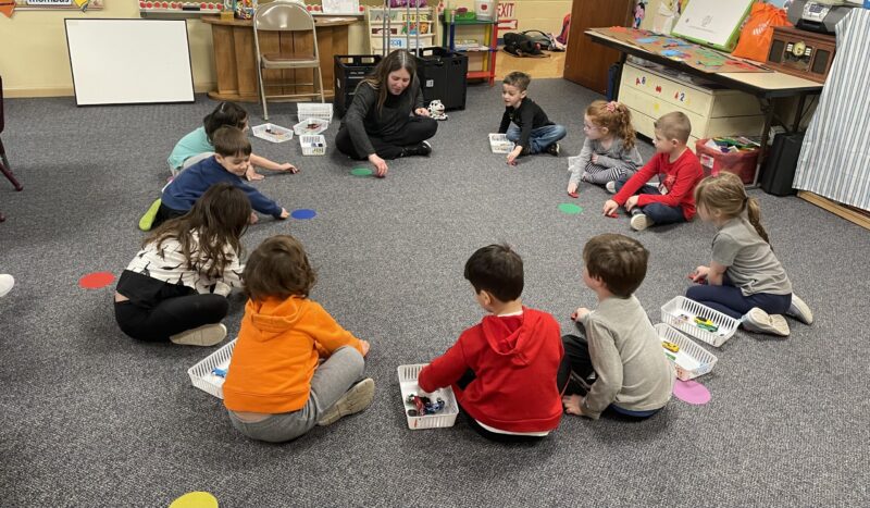 Preschool children in a circle with teacher